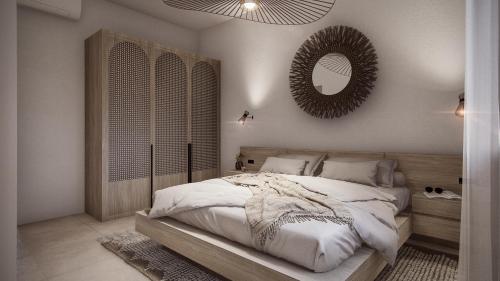 a bedroom with a large bed and a mirror at Seaview House Cala Gonone in Cala Gonone