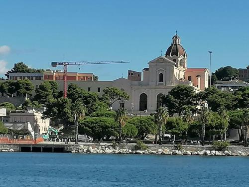 a church sitting on top of a hill next to the water at Luxury Rooms Paoli 19 in Cagliari