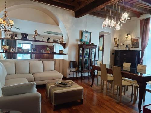 a living room with a couch and a dining room at Magnifico appartamento @Turin in Turin