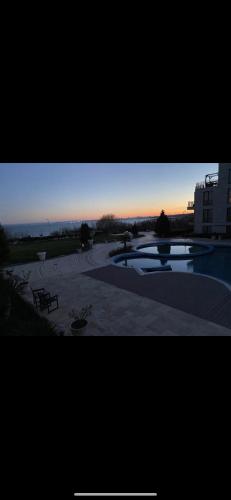 a view of a park with a sunset in the background at Diamond Beach Sea View Studios in Burgas