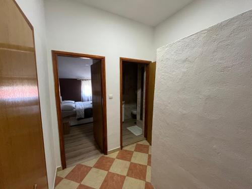 a hallway with a room with a bed and a mirror at Apartments Mira in Bibinje