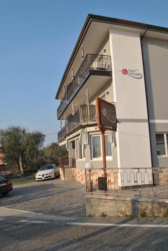 a building with a car parked in a parking lot at Hotel Casa Gagliardi in Brenzone sul Garda