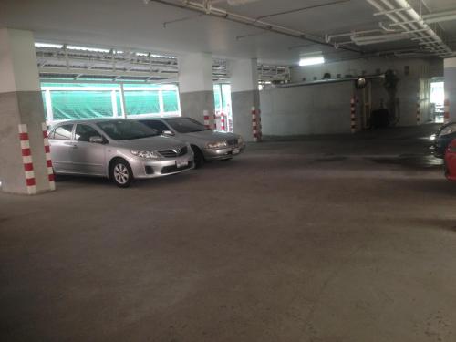 a parking garage with three cars parked in it at Bangkok 68 in Bangkok