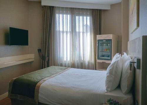 Ein Bett oder Betten in einem Zimmer der Unterkunft Hotel Troya