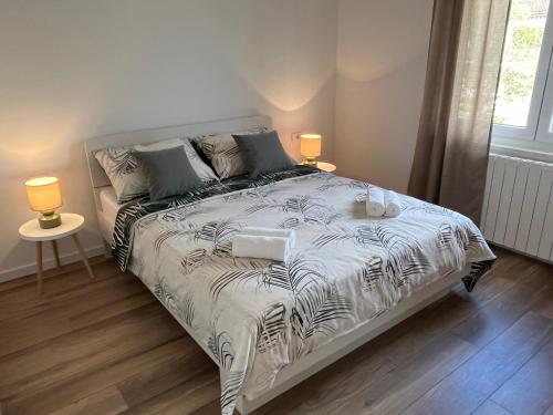 a bedroom with a bed with a black and white comforter at Apartment Bencic in Fažana