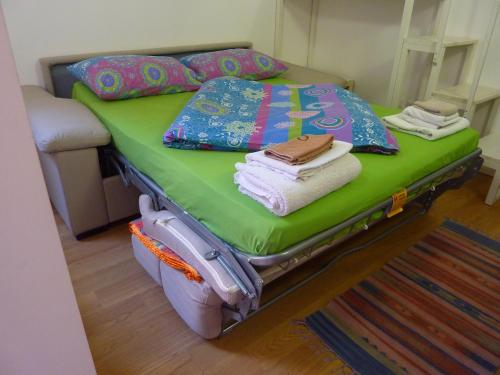 a bedroom with a bed with towels and pillows at Porta Venezia Studios Lambro 15 in Milan