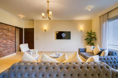 a living room with a couch and a tv at The Suites near AUC by Elegant Hospitality in Cairo