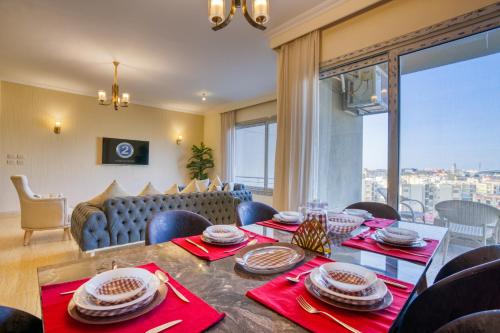 a dining room with a table and a couch at The Suites near AUC by Elegant Hospitality in Cairo