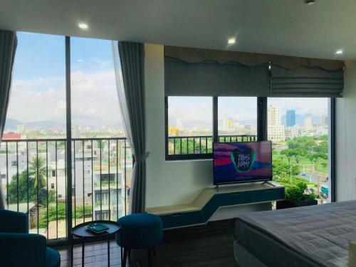1 dormitorio con 1 cama y TV en una ventana en Cali hotel books Da Nang, en Da Nang