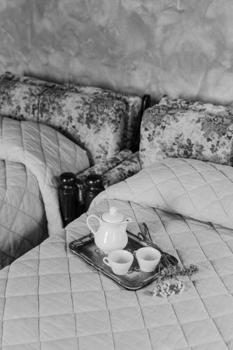 a tray with cups and a tea set on a bed at Villa Nottola in Montepulciano