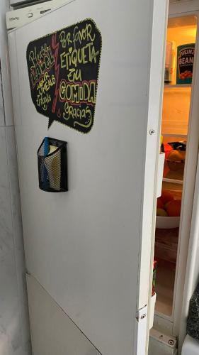 a refrigerator with a sign on the side of it at Hostel Santander in Santander