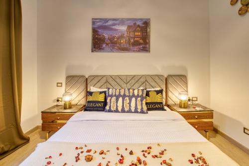 a bedroom with a large bed with flowers on it at The Suites near AUC by Elegant Hospitality in Cairo
