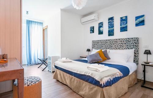 a bedroom with a large bed with blue and white at Retro Guest House in Rome