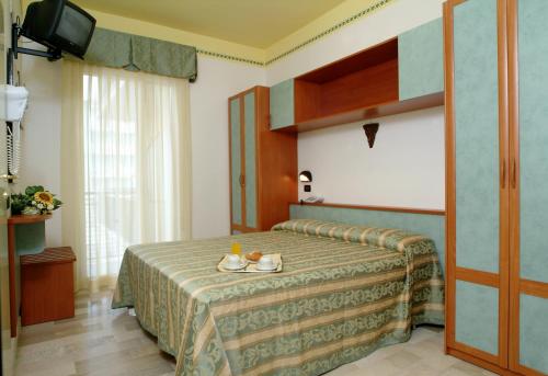 Postel nebo postele na pokoji v ubytování Hotel Grado