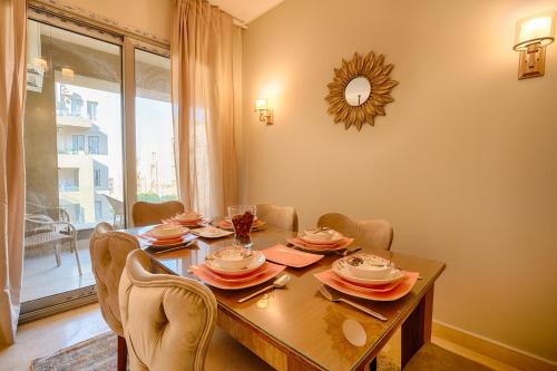 a dining room with a table and chairs and a window at The Suites near AUC by Elegant Hospitality in Cairo