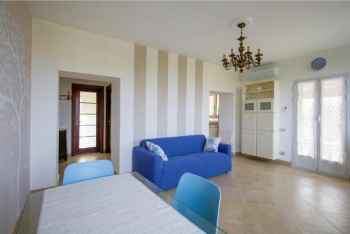 a living room with a blue couch and a table at La Quercia casa vacanza Imperia in Imperia