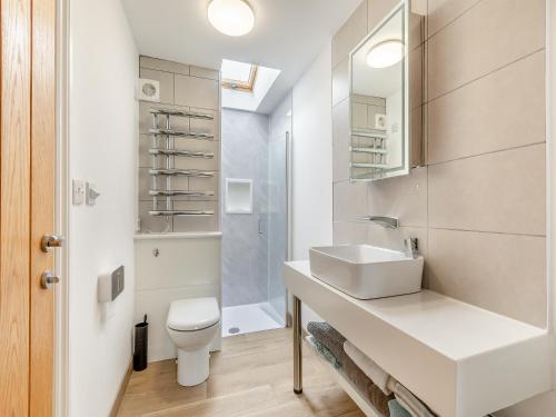 a white bathroom with a sink and a toilet at Honey Bee - Uk43395 in Chardstock