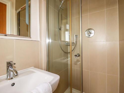 a bathroom with a shower and a sink at 207 The Glades - Retallack Resort and Spa in Saint Columb Major