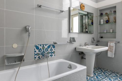 a white bathroom with a sink and a tub and a toilet at Italy Prestigious Guest House in Bologna