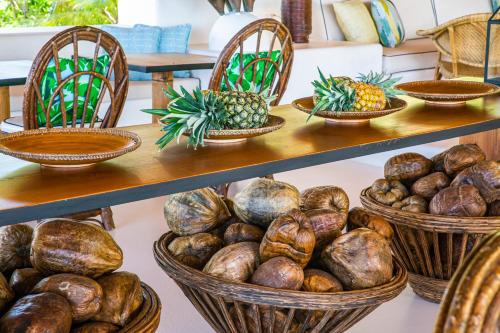 a display of baskets of coconuts and pineapples at Hotel Agua Baru by Mustique in Baru
