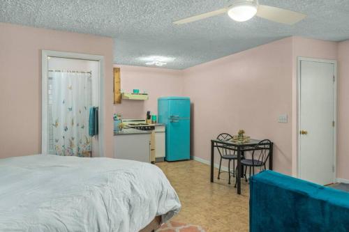 a bedroom with a bed and a blue refrigerator at On Sebring CirclePrivate studio apartmentw/balcony in Sebring