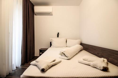 a bedroom with two beds with towels on them at Бялата Къща 2 in Zlatograd
