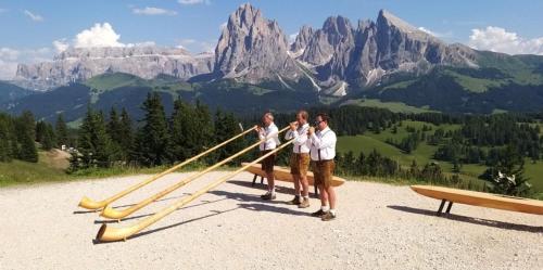 a group of people standing in front of a mountain at Binterhof in Castelrotto