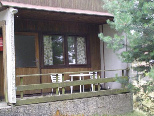 a house with two chairs and a table on the porch at Pension U Václava in Janov