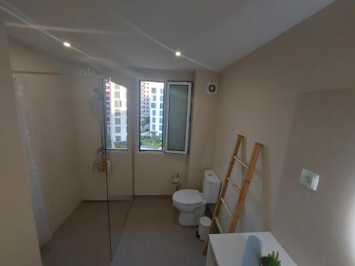 a bathroom with a toilet and a glass shower at Horizon Dream in Funchal