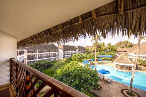 a balcony view of a resort with a swimming pool at Nungwi Beach Resort by Turaco in Nungwi