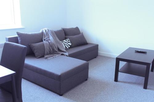 a living room with a couch and a table at 1Bed Apartment in Heywood with Transport Links in Heywood