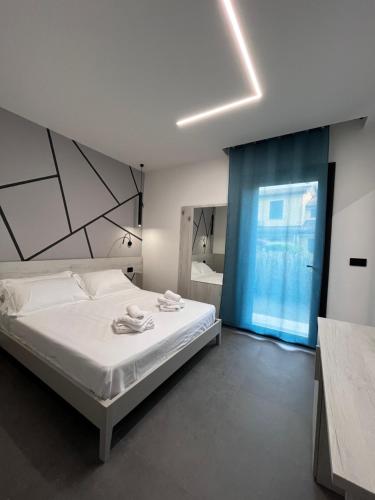 a bedroom with a bed and a large window at B&B A due passi dal mare in Lido di Pomposa