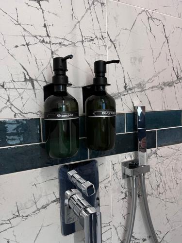 two bottles of soap are sitting on a bathroom counter at B&B A due passi dal mare in Lido di Pomposa