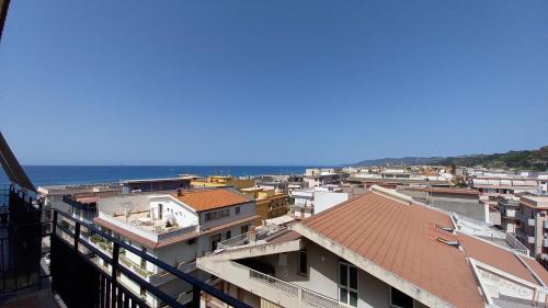 a view of a city with the ocean in the background at Appartement Spadafora - 50m de la plage in Spadafora