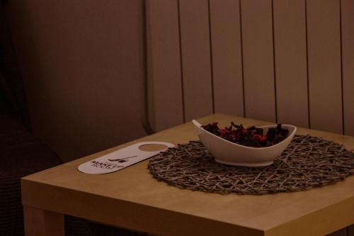 a bowl of fruit on a table with a spoon at Hotel Biergarten Hilde in Medulin