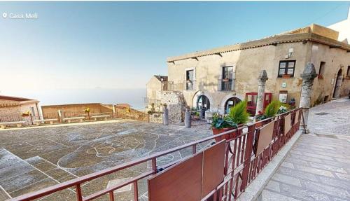 an old building with a fence in front of it at Bed & Breakfast StudioArcodia- in San Marco dʼAlunzio