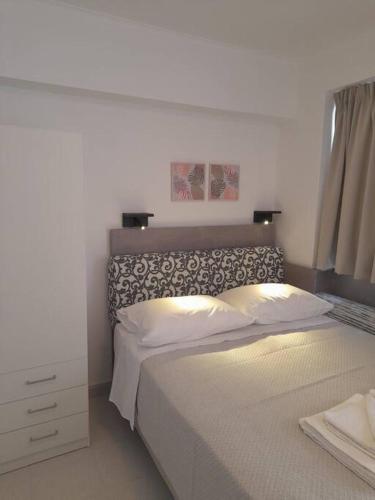 a bedroom with a large bed and a night stand at CorfuCenterStudios2 in Corfu