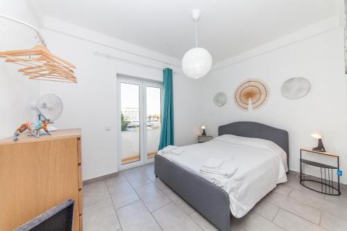 a bedroom with a bed and a large window at Vasco Da Gama Apartments in Lagos