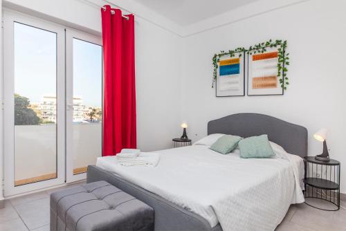 a bedroom with a large bed with a red curtain at Vasco Da Gama Apartments in Lagos