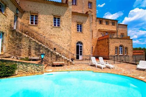 a large swimming pool in front of a building at SPECIAL ! LE STUDIO DU CHATEAU in Tourrettes