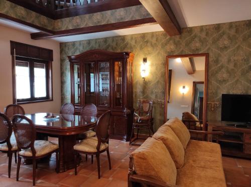 a living room with a table and a couch at Casa Felisa Pirineo Aragonés in Santa Eulalia de Gállego