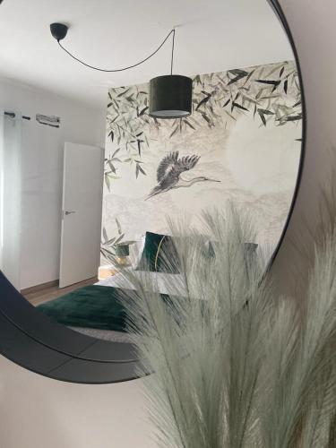 a bedroom with a mirror and a bed with birds at Las Casas de Lola in Candeleda