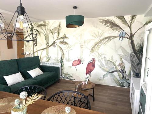 a living room with a bird mural on the wall at Las Casas de Lola in Candeleda