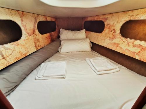 1 cama blanca grande en una habitación pequeña con ventanas en Lanzarote Pirat en Arrecife