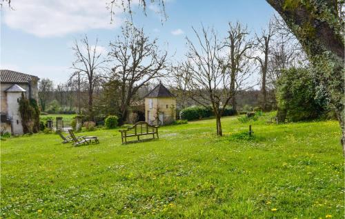 a park with two benches in a grassy field at Gorgeous Home In Coutras With Wifi in Coutras