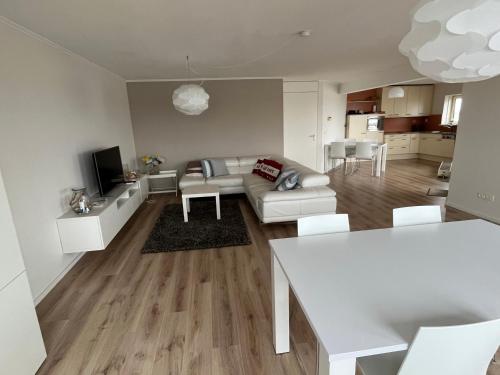 a living room with a couch and a table at Appartement Marina Port Zélande - Brouwersdam Zeeland in Ouddorp