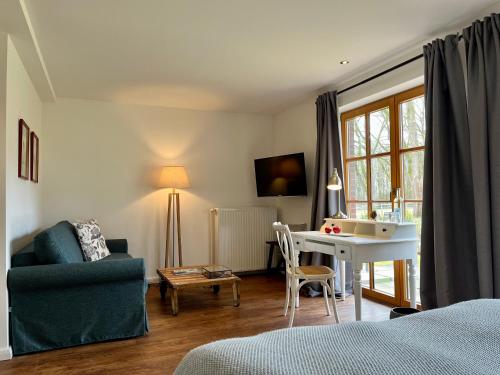 a bedroom with a desk and a chair and a table at Stimbekhof in Bispingen