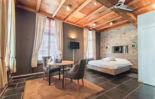a bedroom with a bed and a table and chairs at Nice Home In Damme With Wifi in Damme
