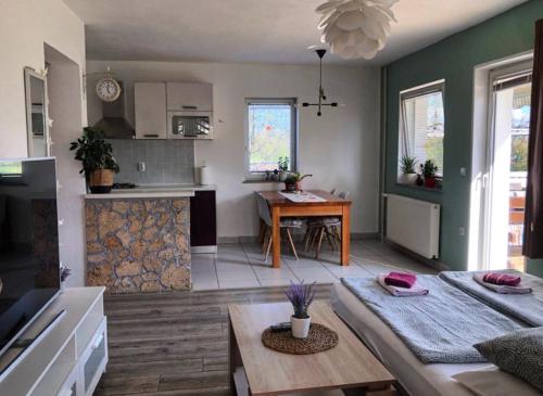 a living room with a table and a kitchen at House Antonia in Grabovac