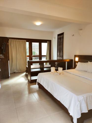 a bedroom with a large bed and a large window at Hotel Sao Francisco in Jericoacoara